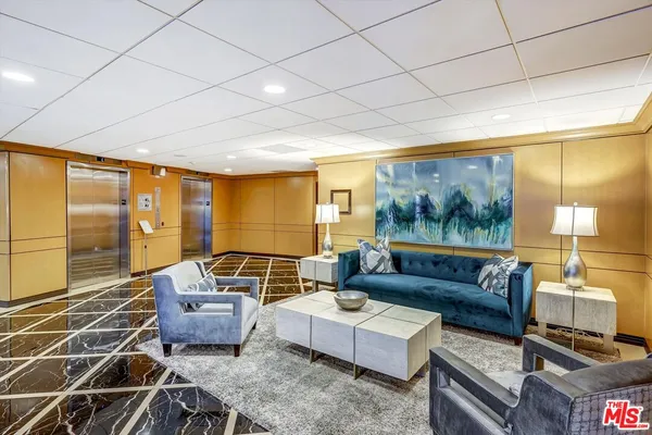 a living room with furniture and a floor to ceiling window