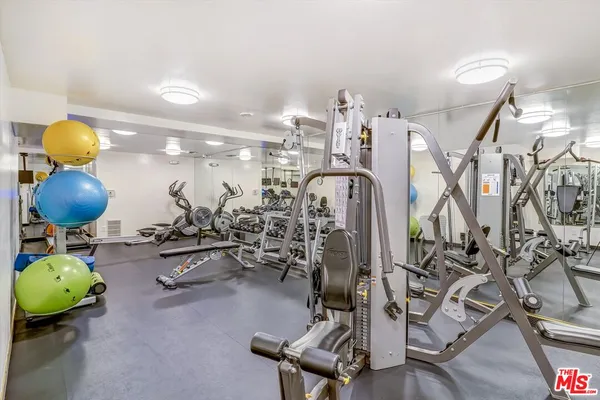 a room with gym equipment and air hockey table