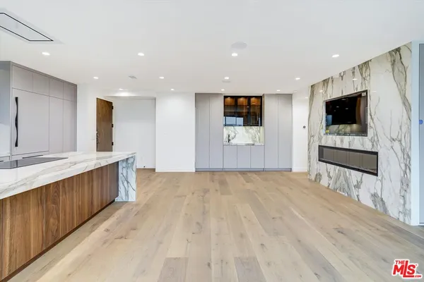 a view of kitchen with wooden floor and electronic appliances