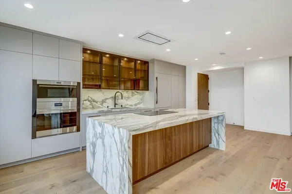 a kitchen with stainless steel appliances granite countertop a sink and cabinets