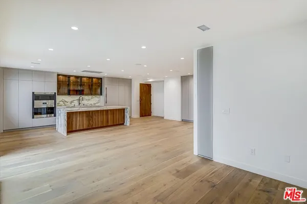 a view of a kitchen with a sink and a fireplace