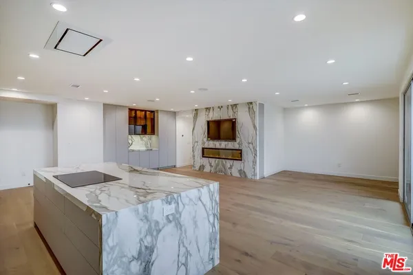 a large kitchen with stainless steel appliances kitchen island a large counter top and a stove