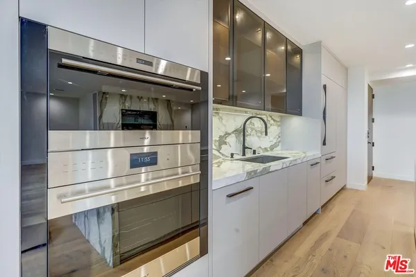 a kitchen with stainless steel appliances granite countertop a sink and cabinets