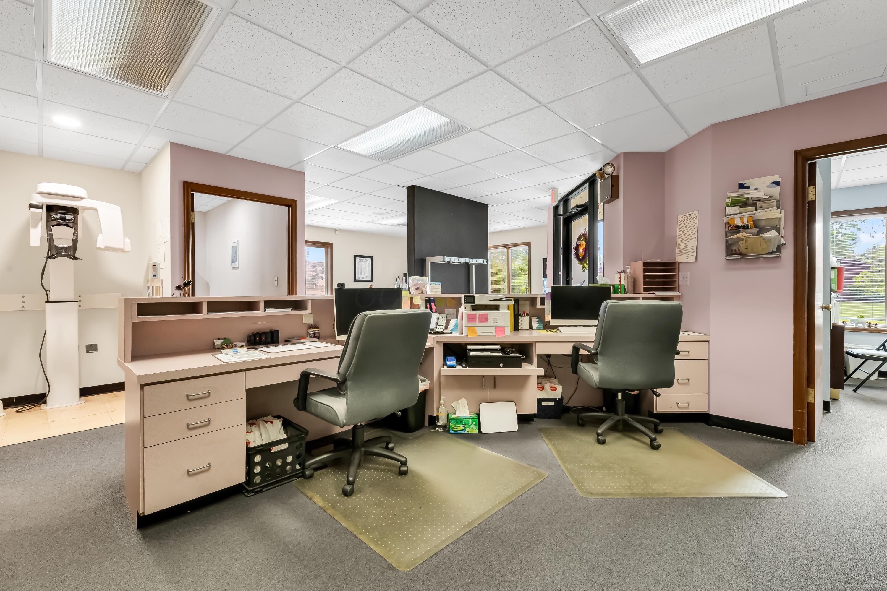 1240 Crescent Heights Road Marion, OH 43302 - Photo 18 of 60 • Blue carpet • Pink painted walls • Acoustic ceiling tiles • Fluorescent lighting • Receptionist counter