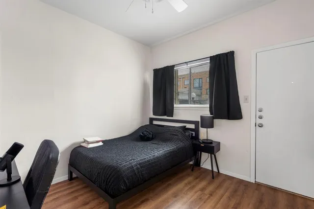 a bedroom with a bed and a flat tv screen on the dresser