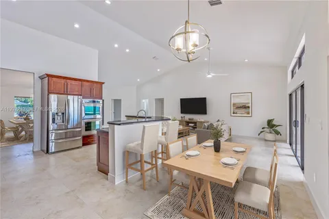a view of a dining room with furniture wooden floor and chandelier