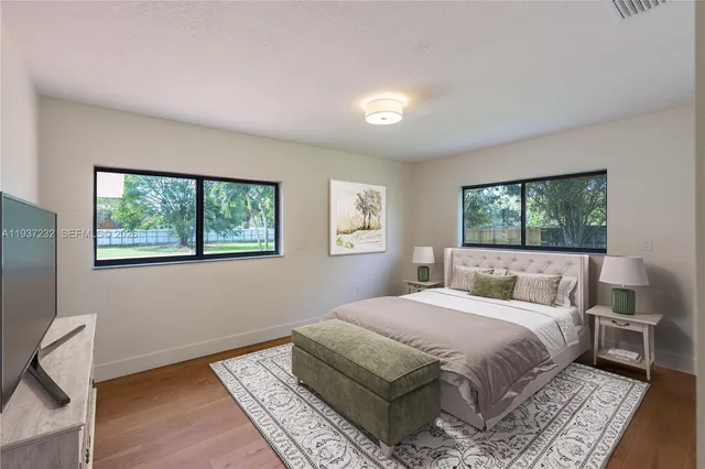 a bedroom with a large bed and a window