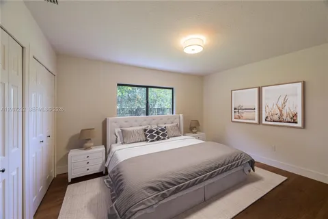 a bedroom with a large bed and a window