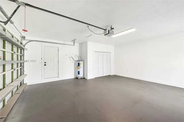an aerial view of a house with swimming pool lawn chairs and large trees