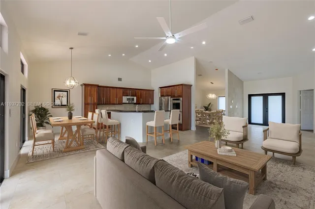 a living room with furniture and kitchen view
