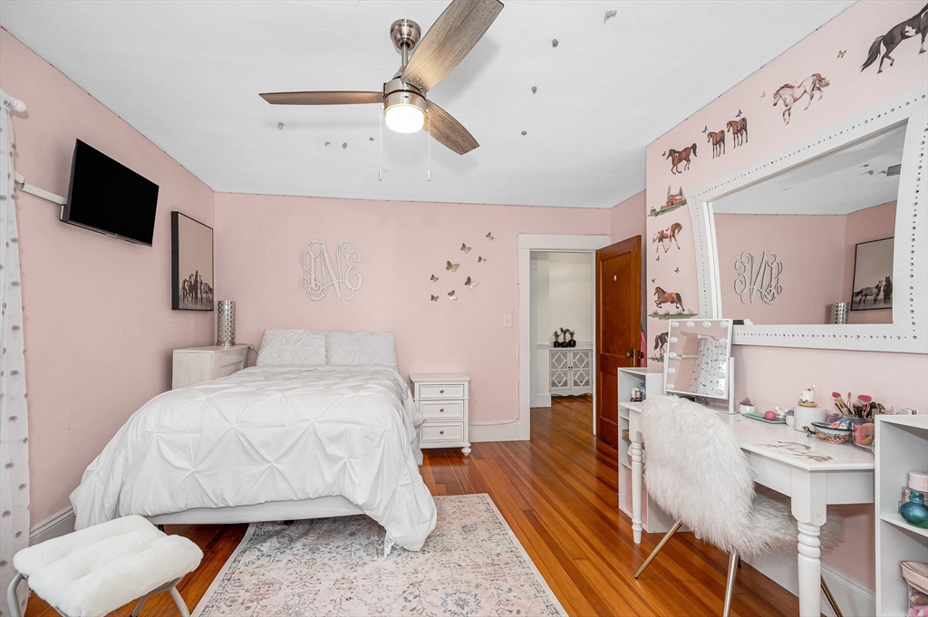 567 Andover Street, Unit A Lowell, MA 01852 - Photo 17 of 35 a bedroom with a bed and flat screen tv