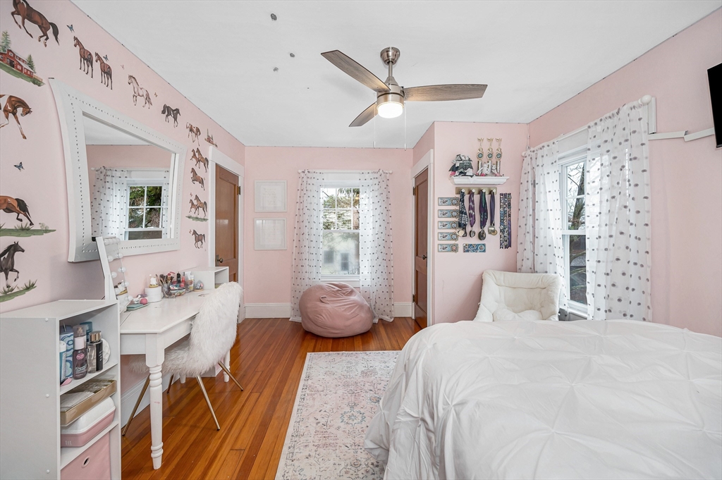 567 Andover Street, Unit A Lowell, MA 01852 - Photo 18 of 35 a bedroom with a bed and wooden floor
