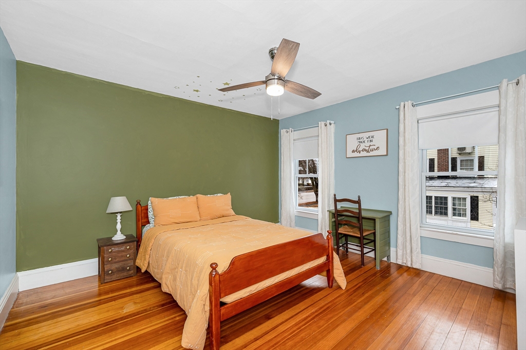 567 Andover Street, Unit A Lowell, MA 01852 - Photo 20 of 35 a bedroom with a bed and a table in it