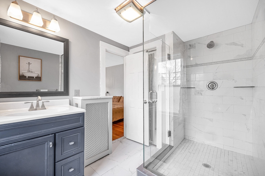 567 Andover Street, Unit A Lowell, MA 01852 - Photo 27 of 35 a bathroom with a double vanity sink mirror and shower