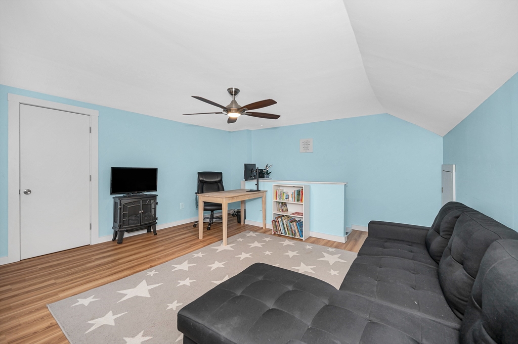 567 Andover Street, Unit A Lowell, MA 01852 - Photo 29 of 35 a living room with furniture and a flat screen tv