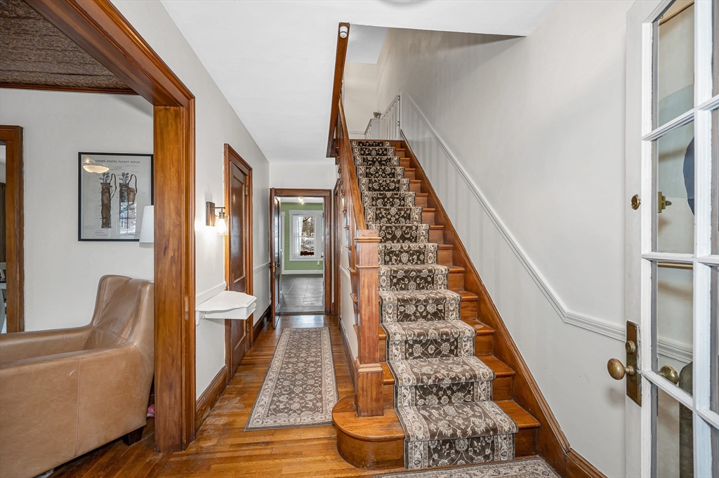 567 Andover Street, Unit A Lowell, MA 01852 - Photo 3 of 35 a view of a hallway with wooden floor and staircase