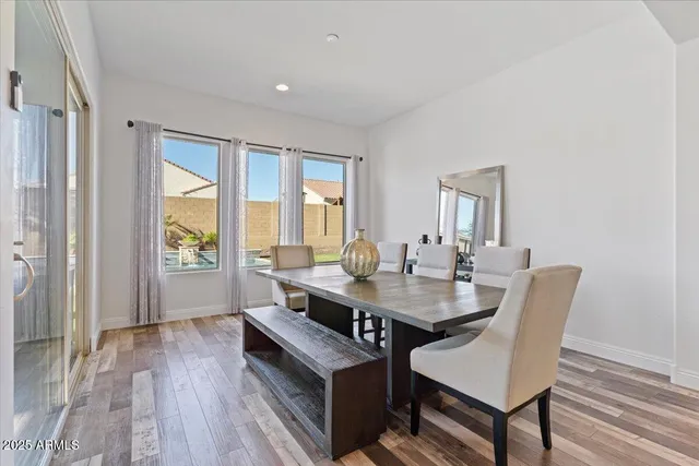 a bedroom with a bed and painting on the wall