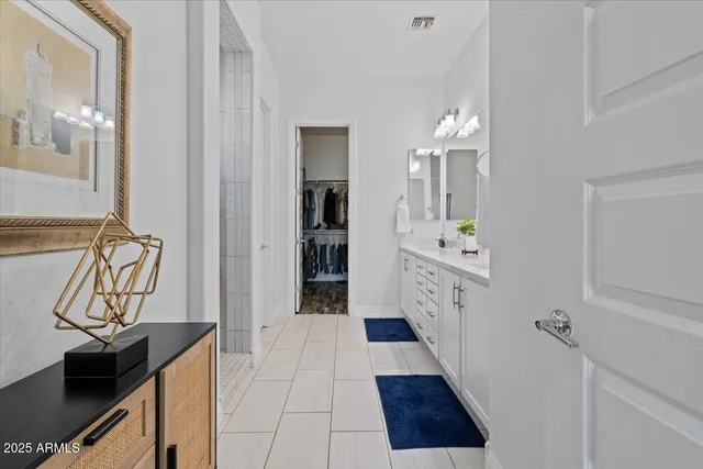 a bathroom with a sink mirror and toilet