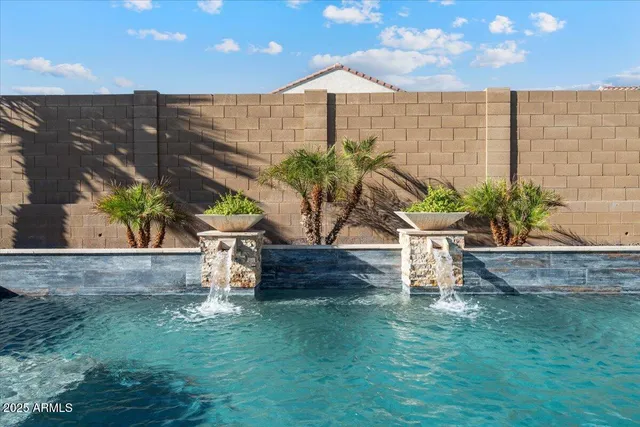 an aerial view of a house with a pool
