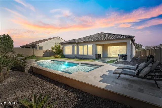 a view of a workspace with furniture and a gate