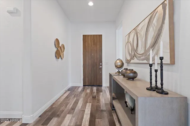a large white kitchen with lots of counter space a sink appliances and cabinets
