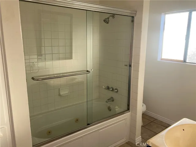 a bathroom with a shower and a sink