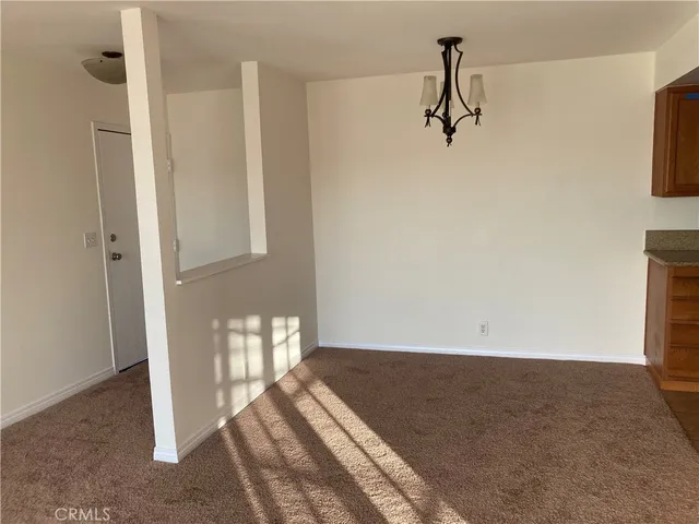 a view of a room with wooden floor and windows