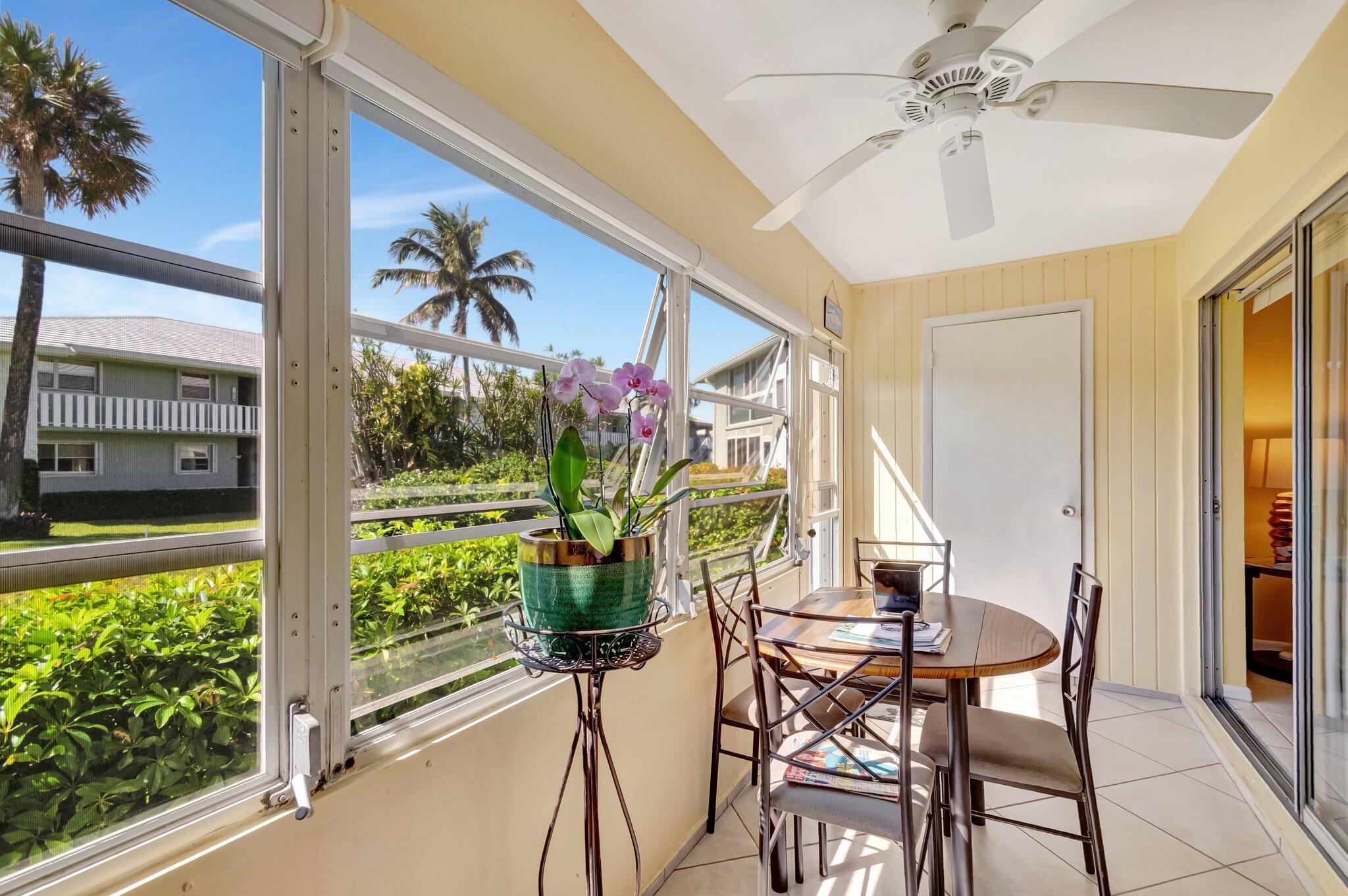 5550 North Ocean Boulevard, Unit 114 Ocean Ridge, FL 33435 - Photo 14 of 54 a view of a porch with a dining table and chairs