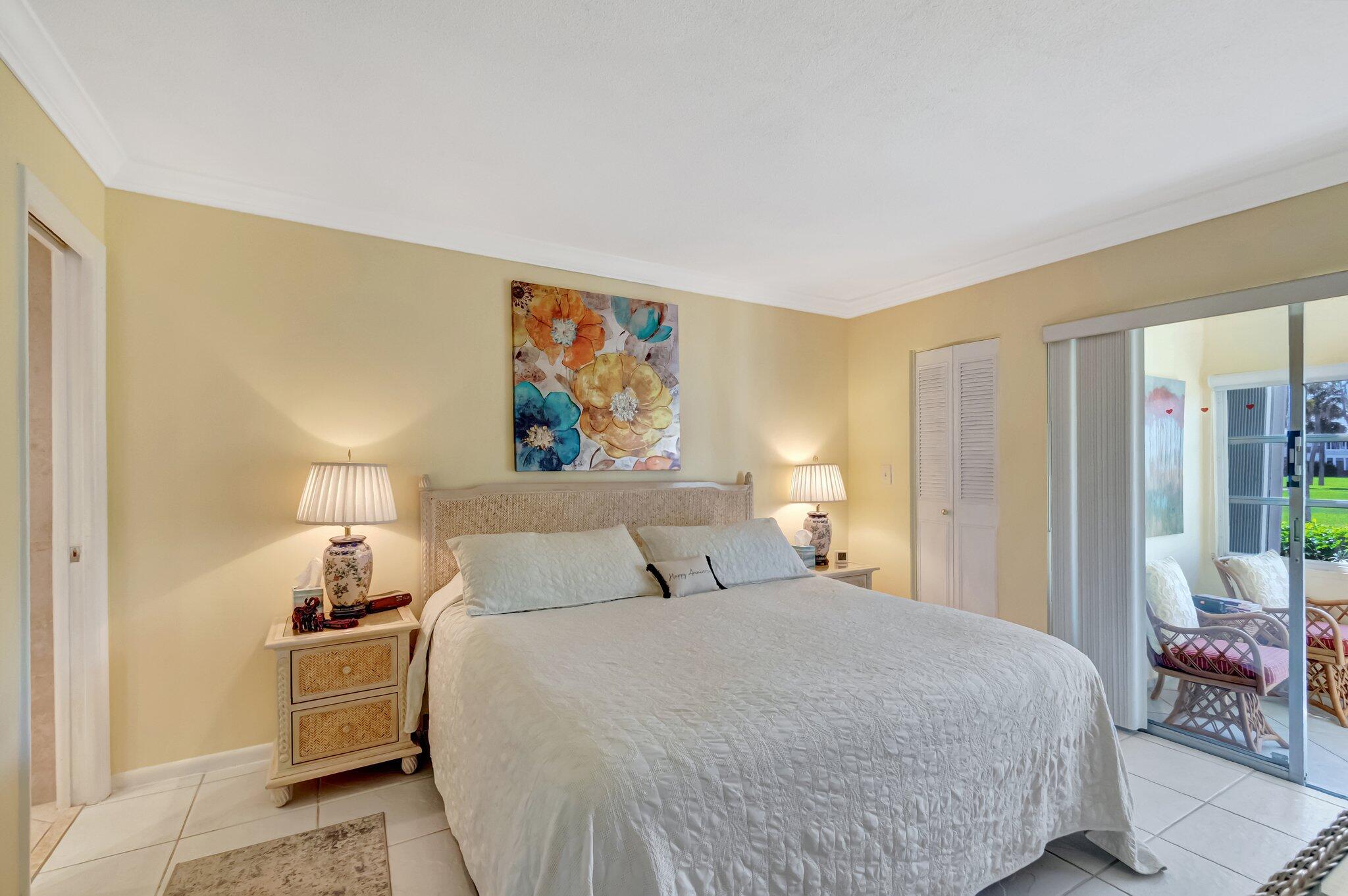 5550 North Ocean Boulevard, Unit 114 Ocean Ridge, FL 33435 - Photo 17 of 54 a bedroom with a bed and wooden floor