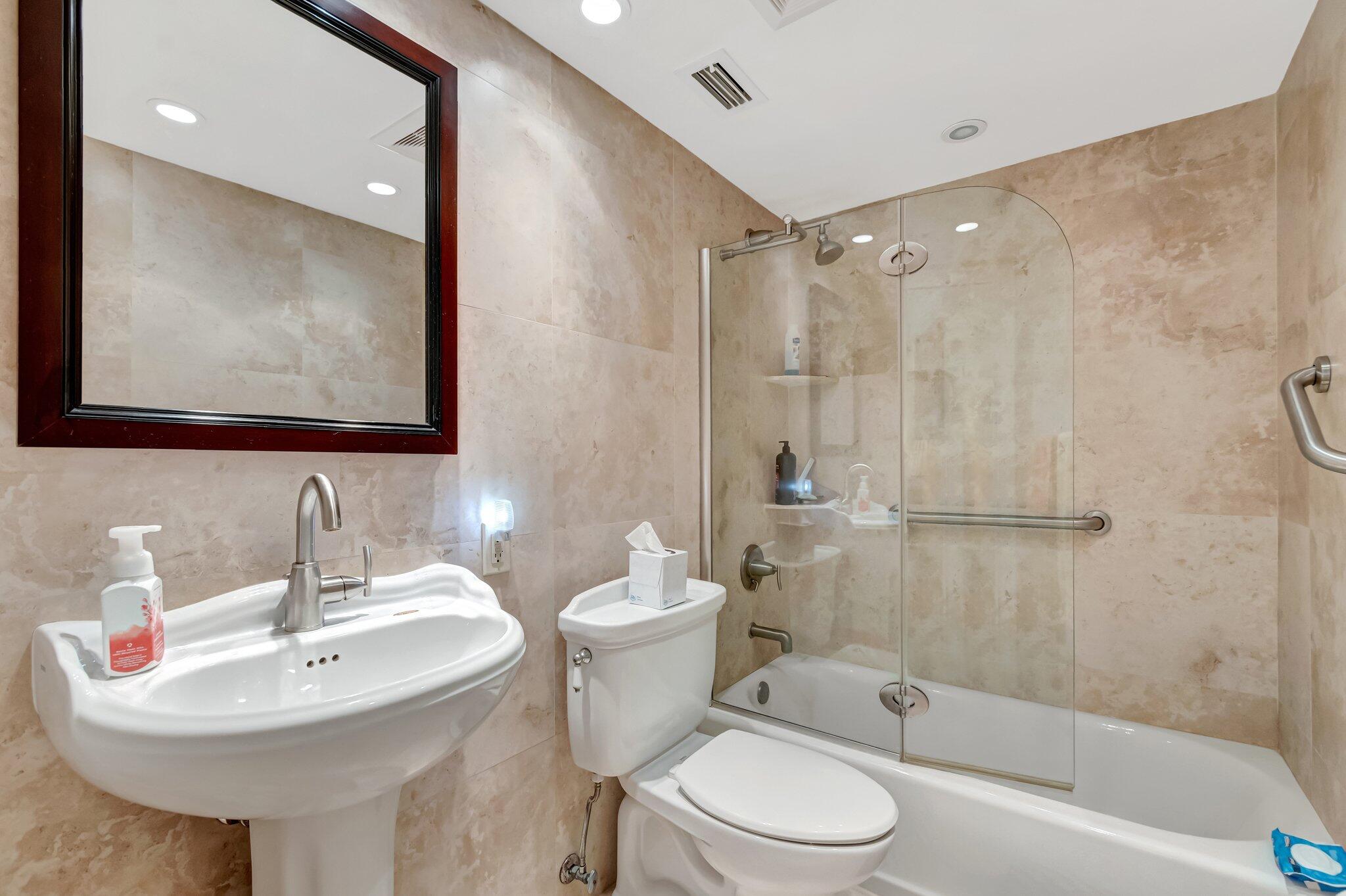 5550 North Ocean Boulevard, Unit 114 Ocean Ridge, FL 33435 - Photo 19 of 54 a bathroom with a sink toilet and shower