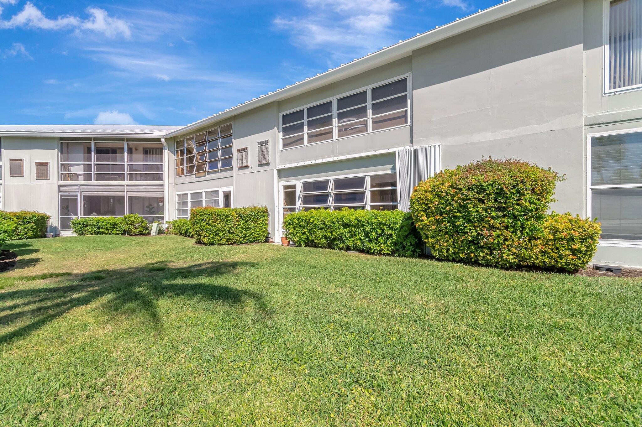 5550 North Ocean Boulevard, Unit 114 Ocean Ridge, FL 33435 - Photo 23 of 54 a view of a house with backyard and garden