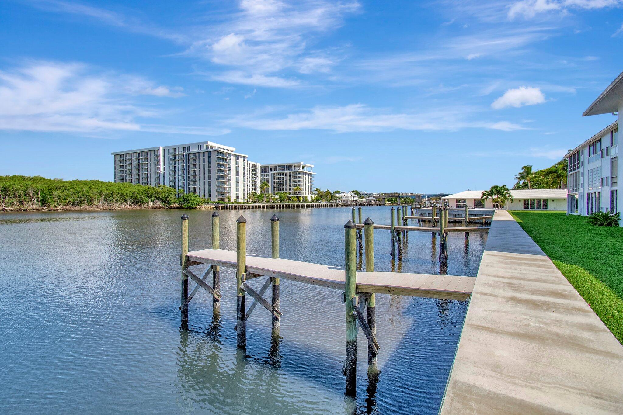 5550 North Ocean Boulevard, Unit 114 Ocean Ridge, FL 33435 - Photo 41 of 54 a balcony with wooden floor table and chairs