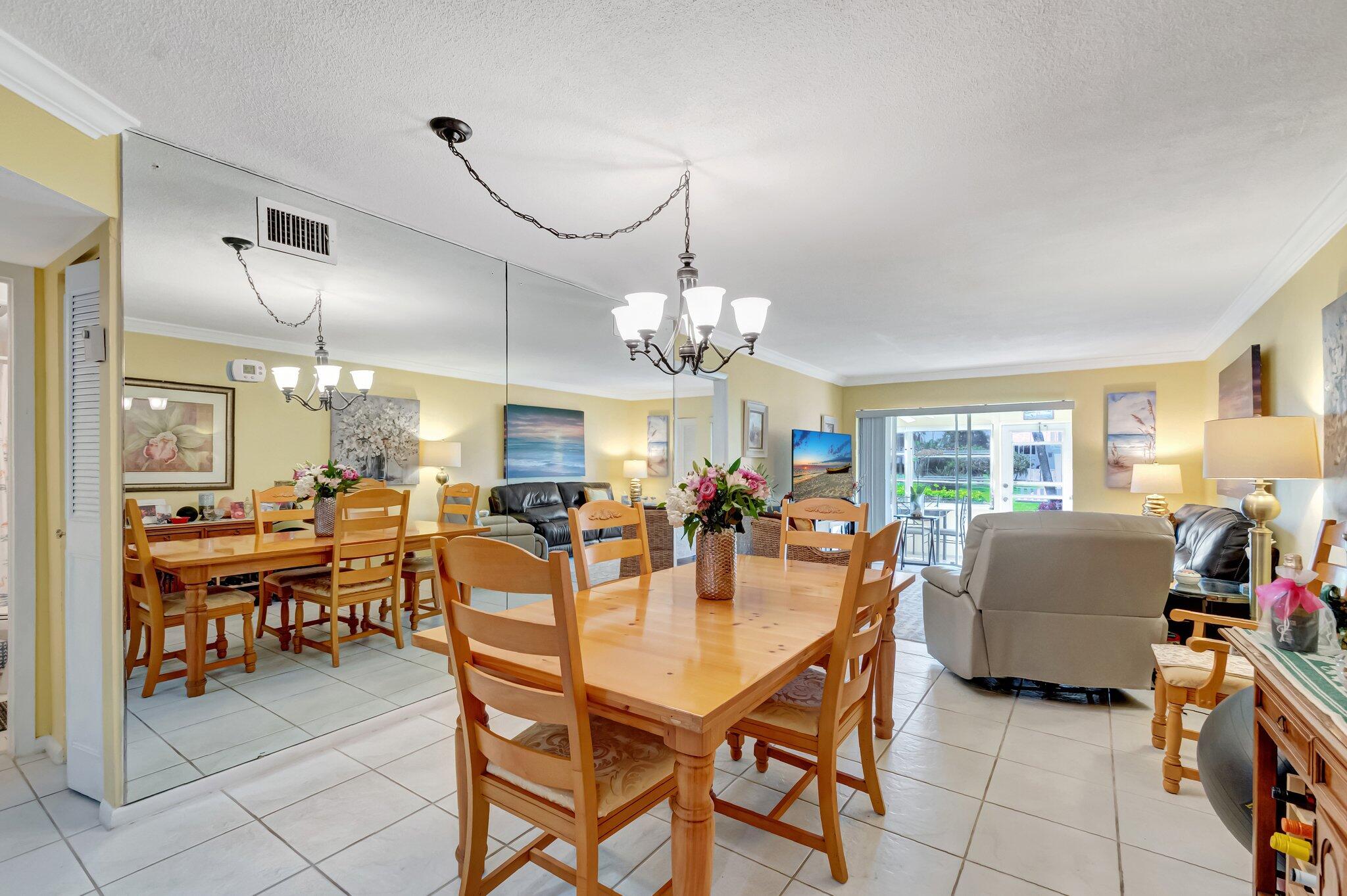 5550 North Ocean Boulevard, Unit 114 Ocean Ridge, FL 33435 - Photo 7 of 54 a dining room filled with lots of furniture and chandelier