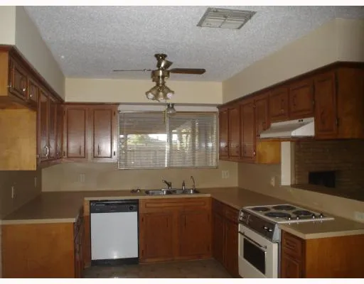 a kitchen with granite countertop a stove and a sink
