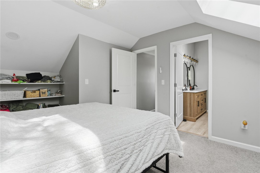 2950 Fairfield Pike Springfield, OH 45502 - Photo 29 of 48 Bright and airy bedroom with sloped ceilings connects to a well-appointed private bath.