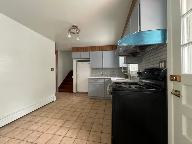 a kitchen with a sink a stove and refrigerator