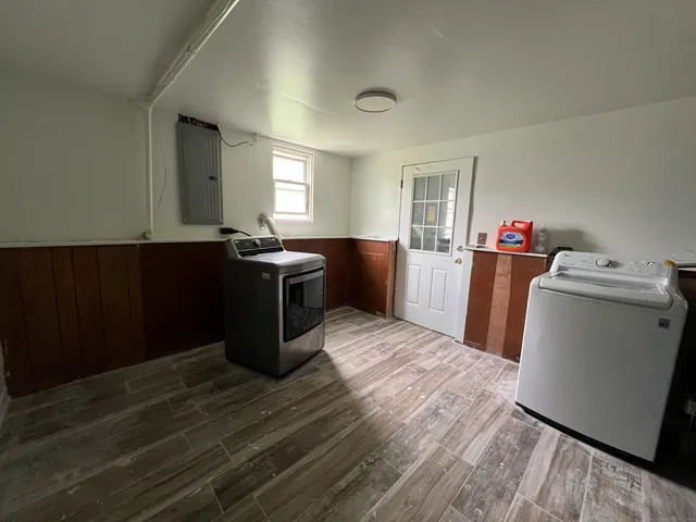 a room with wooden floor and furniture
