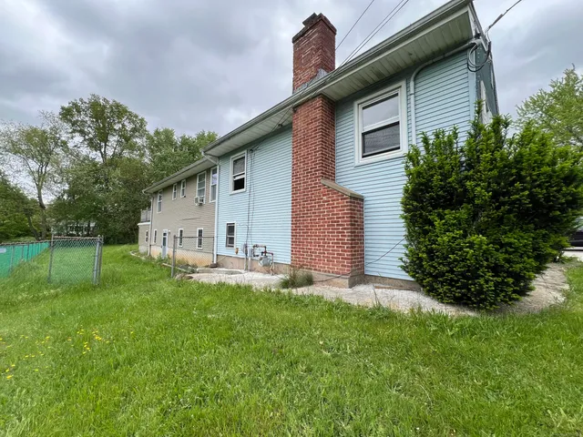 a front view of house with yard and green space