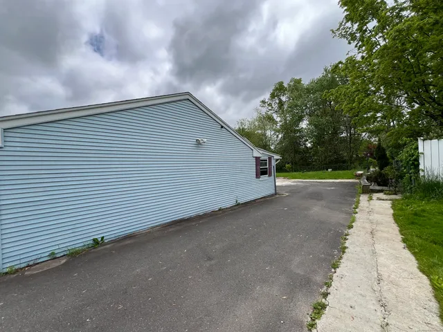 a view of a house with a backyard