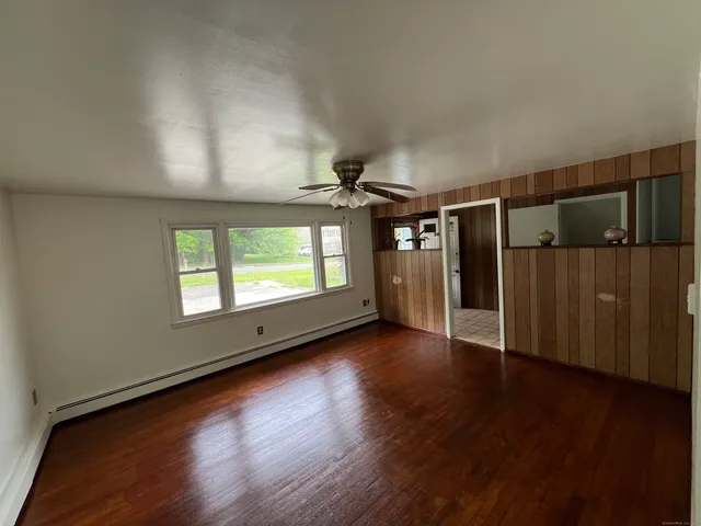 wooden floor in an empty room with a window