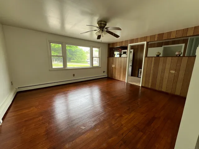 wooden floor in an empty room with a window