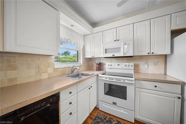 a kitchen with appliances cabinets and a sink