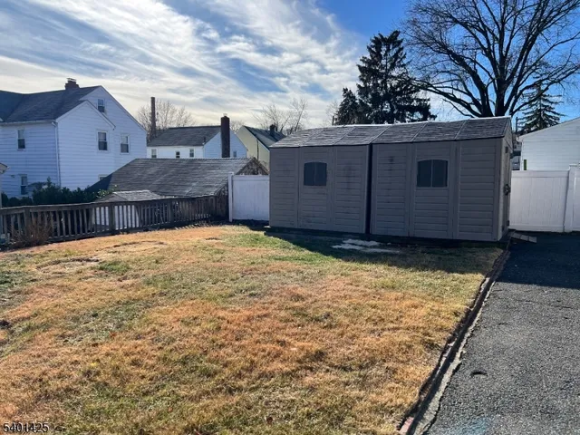 a view of a house with a wooden fence