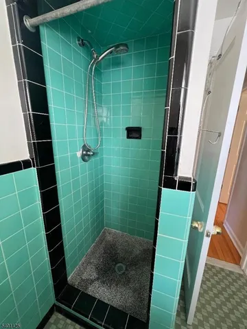 a bathroom with a green toilet and a shower