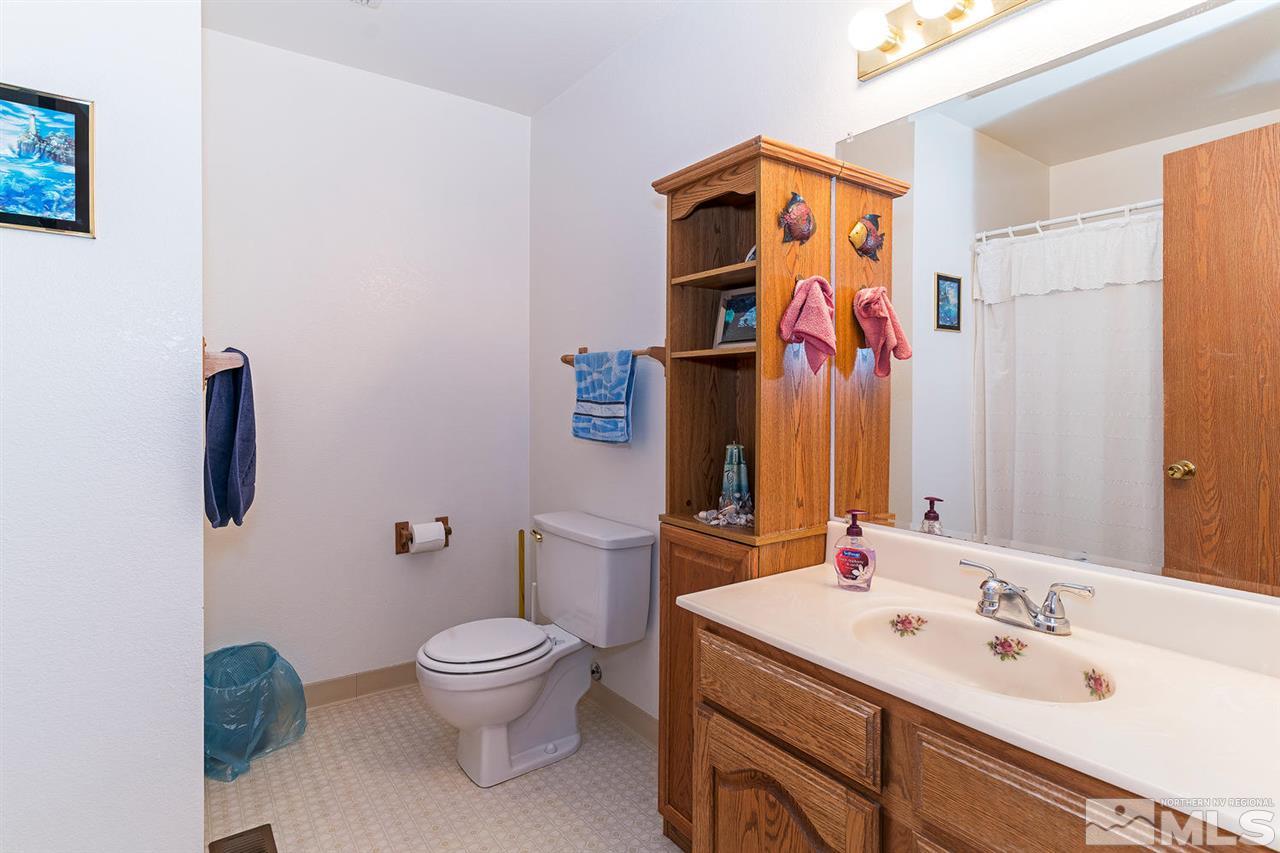 14585 Seminole Trail Reno, NV 89521 - Photo 12 of 15 a bathroom with a toilet sink and mirror
