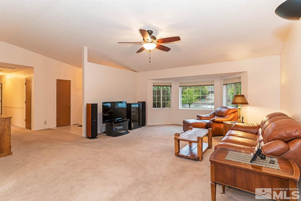 14585 Seminole Trail Reno, NV 89521 - Photo 3 of 15 a living room with furniture a ceiling fan and a flat screen tv