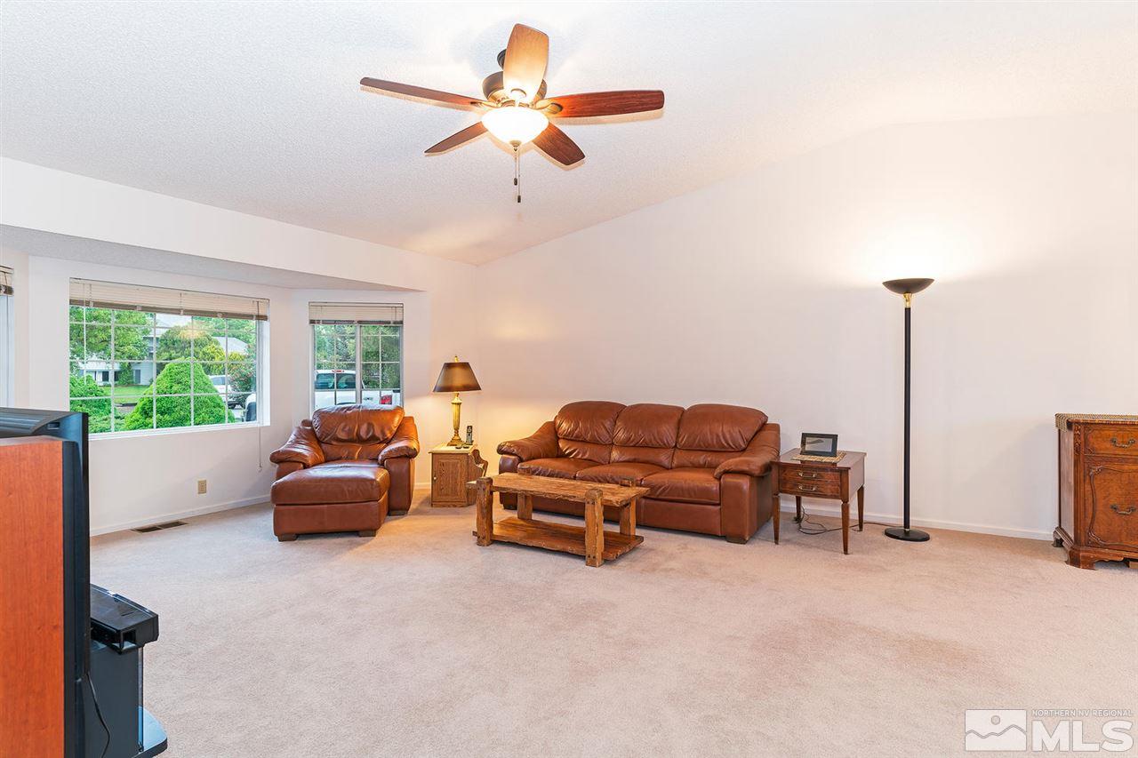 14585 Seminole Trail Reno, NV 89521 - Photo 4 of 15 a living room with furniture a window and a chandelier