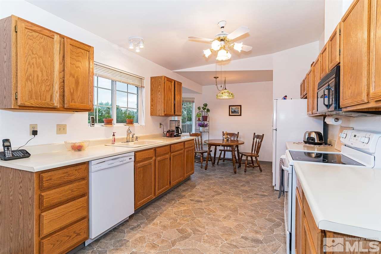 14585 Seminole Trail Reno, NV 89521 - Photo 6 of 15 a kitchen with a sink stove and cabinets