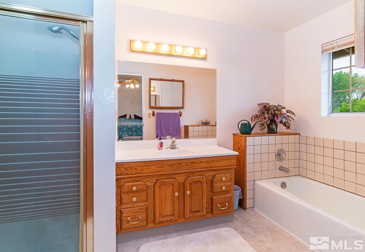 14585 Seminole Trail Reno, NV 89521 - Photo 9 of 15 a bathroom with a tub sink and mirror