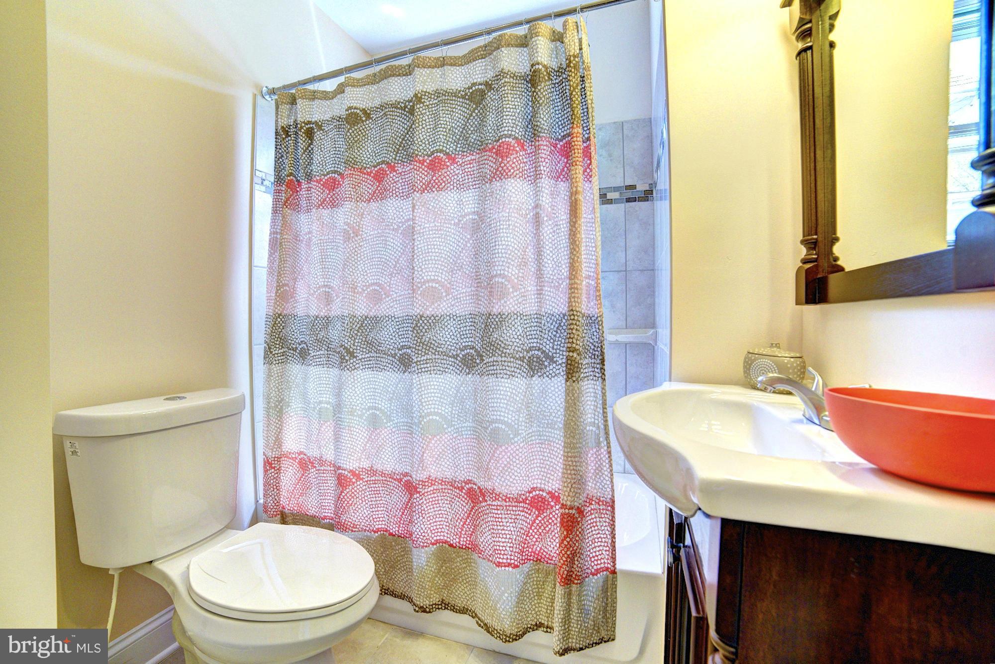 5408 Catalpha Road Baltimore, MD 21214 - Photo 11 of 23 a bathroom with a sink toilet and shower